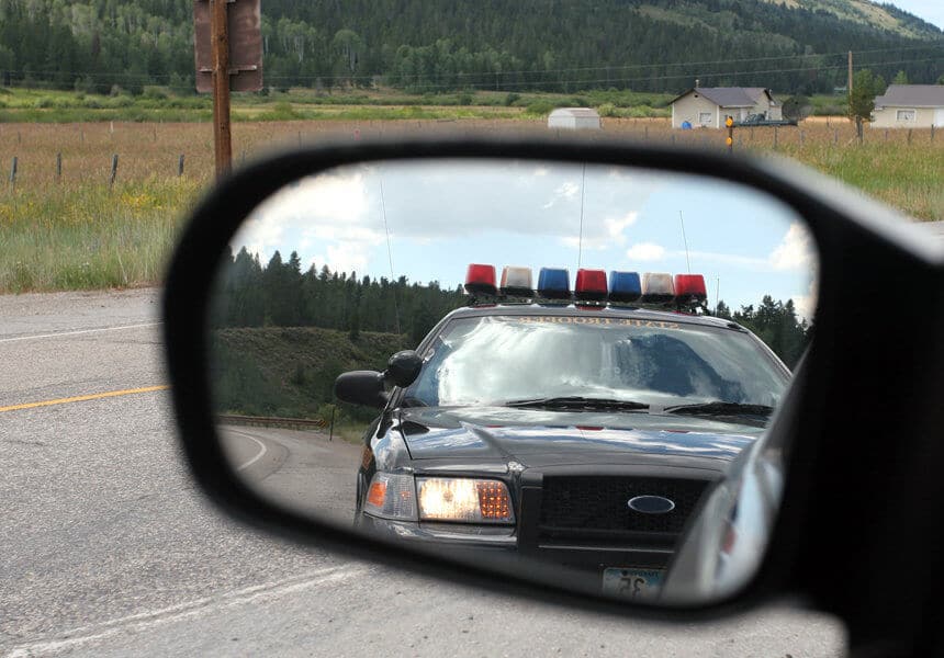 police car seen in the side mirror